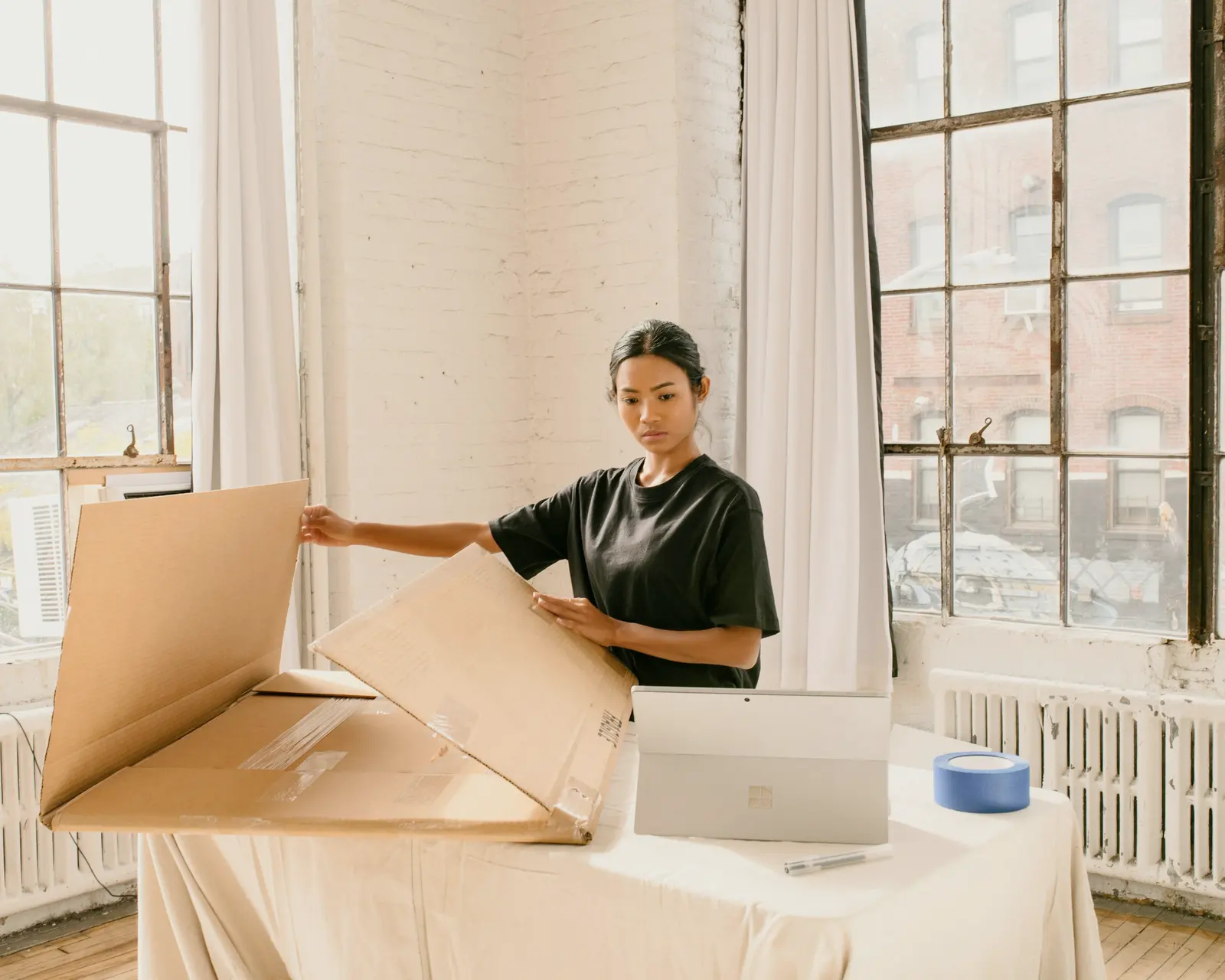 Store owner packing an order in her studio